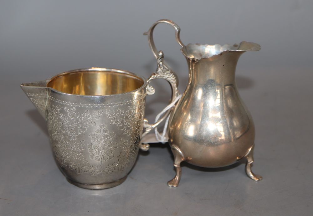 A late Victorian engraved silver sparrow beak cream jug, London, 1890, 82mm and a later silver cream jug, 5oz.